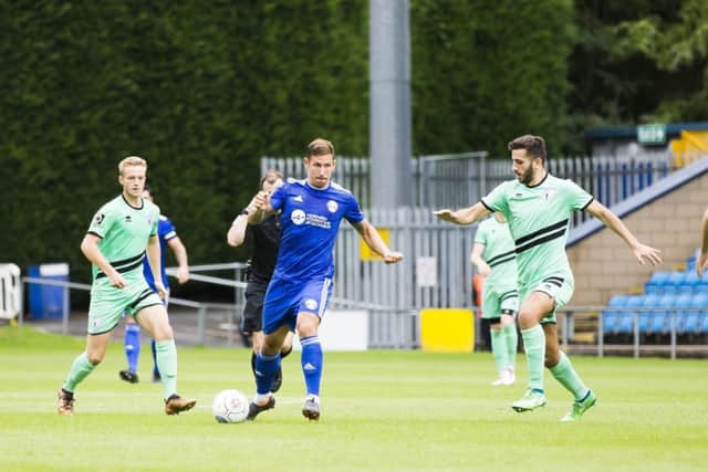 ON THE UP: Action from the recent FC Halifax Town clash against Gateshead. Picture: Jim Fitton.
