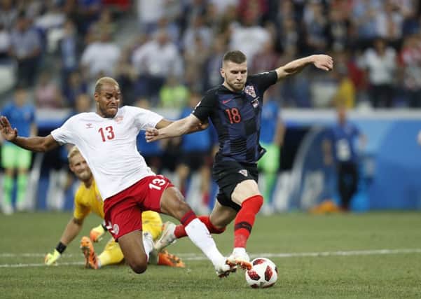 Huddersfield's Mathias Jorgensen, le in action for Denmark against tries to stop Croatia's Ante Rebic at this summer's World Cup. Picture: PA/Efrem Lukatsky