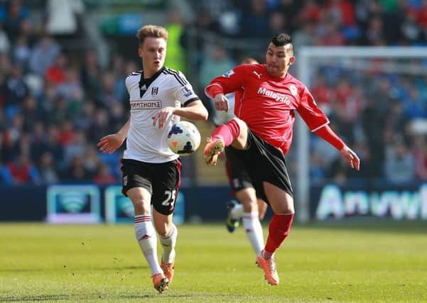 Cauley Woodrow (left), in action for Fulham against Cardiff City. Picture: David Davies/PA