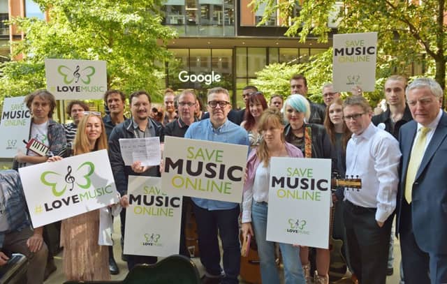 Mp Tom Watson (centre), with Blur drummer Dave Rowntree (centre left), singer-songwriter Crispin Hunt ( fourth left) and singer-songwriter Newton Faulkner (back row, centre left), outside Google in King's Cross, London, to protest tech giant "parasites" in a fight for better remuneration.