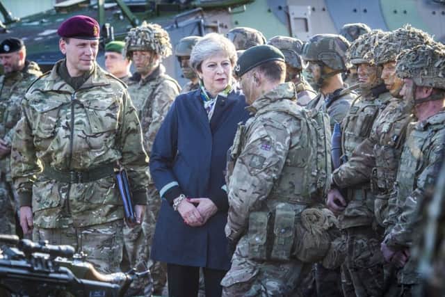 Can Theresa May maintain Britain's military standing in the world?