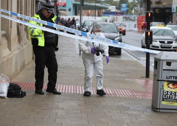 A police and a forensic officer in Barnsley town centre after a serious incident. PIC: PA