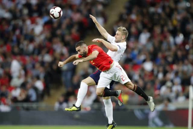 England's Luke Shaw, right, jumps for the ball with Spain's Dani Carvajal Picture: AP/Frank Augstein