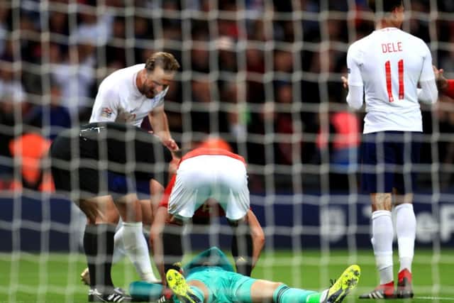 Spain's goalkeeper David De Gea (centre) on the ground as England see a late equaliser disallowed. Picture: Mike Egerton/PA
