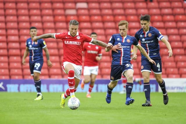 Barnsley's George Moncur battles for possession at Oakwell. Picture: Scott Merrylees