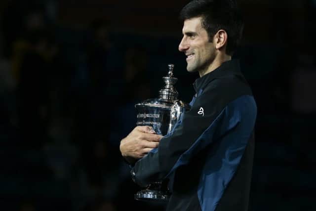 Novak Djokovic, of Serbia, holds the championship trophy after defeating Juan Martin del Potro, of Argentina. (AP Photo/Andres Kudacki)