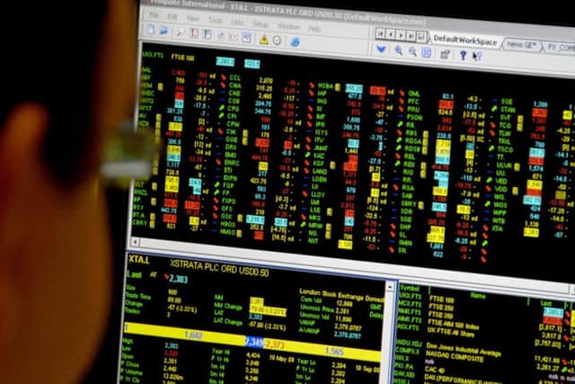 An office worker looks at a screen showing trading on the FTSE 100 index after investors were rocked by the credit crunch claiming Lehman Brothers.
