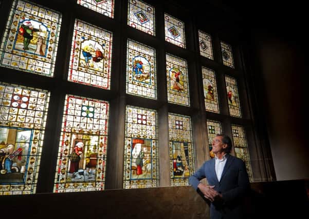 Owner/developer  Henry Kordowitz looks at the spectacular stained glass on the stairway at Spenfield House. Picture Tony Johnson.