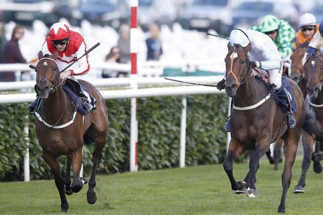 Central City and Ted Durcan pull clear of the Andrew Thornton-ridden Detachment in the Leger Legends race at Doncaster.