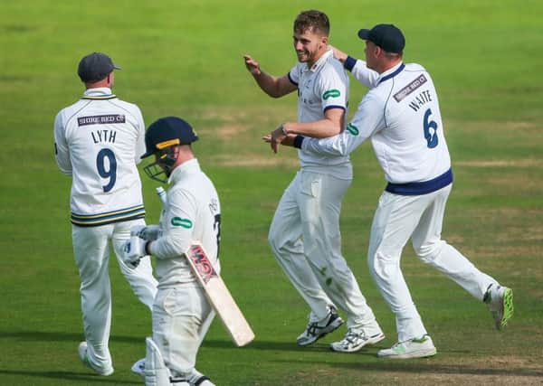 Yorkshire's Ben Coad celebrates with Matthew Waite after taking the wicket of Lancashire's Alex Davies.