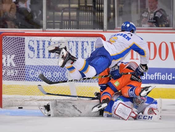 HIDDEN HERO: Jordan Owens, partially obscured, pushes home the puck under pressure to seal a 4-3 overtime win for the Steelers against Fife Flyers. Picture: Dean Woolley
