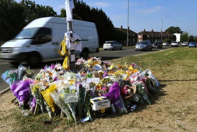 Floral tributes at the car crash site in Broadway,