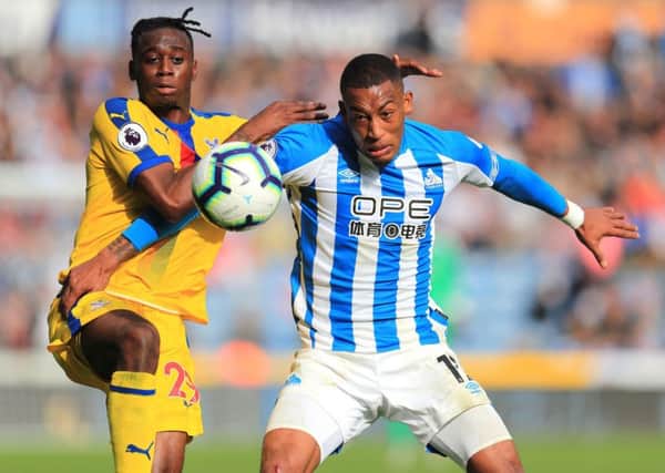 Crystal Palace's Aaron Wan-Bissaka (left) and Huddersfield Town's Rajiv van La Parra battle for the ball.
