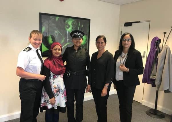 West Yorkshire's chief constable Dee Collins, left, with PC Fiz Ahmed, centre, modelling the alternative uniform at a meeting with the Muslim Women's Council.