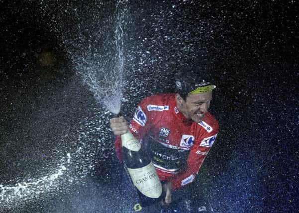 British rider Simon Yates of the Mitchelton-Scott team celebrates on the podium after winning the La Vuelta cycling race in Madrid, Spain.