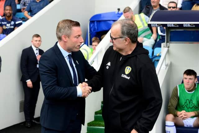 Millwall manager Neil Harris chats to Leeds United head coach Marcelo Bielsa before the match at The Den on Saturday. Picture: James Hardisty.