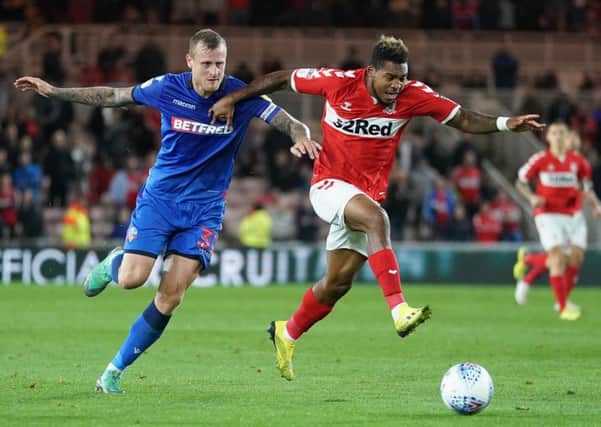 Middlesbrough's Britt Assombalonga (right) and Bolton's David Wheater battle for the ball on Wednesday night at The Riverside. Picture: Owen Humphreys/PA
