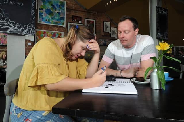 Autistic artist Emy Spinks, pictured with her tutor Samuel Potts