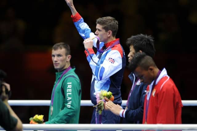 Great Britain's Luke Campbell (centre) celebrates winning gold after defeating Ireland's John Joe Nevin at the London 2012 Olympics. Picture: Anthony Devlin/PA