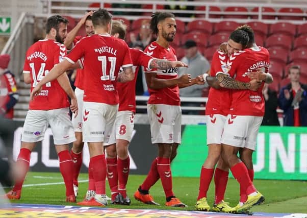 Middlesbrough's Britt Assombalonga (right) is mobbed by team mates after scoring his side's second goal of the game during the Sky Bet Championship match at the Riverside Stadium, Middlesbrough. (Picture: Owen Humphreys/PA Wire)