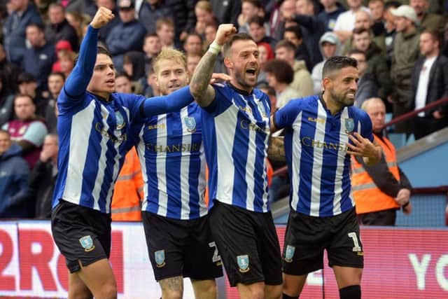 Winner: Steven Fletcher is congratulated after his goal at VIlla Park.