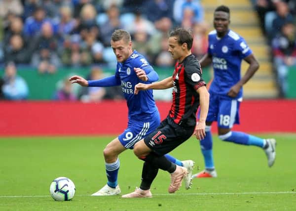 Leicester City's Jamie Vardy (left) and Huddersfield Town's Chris Lowe battle for the ball at the King Power Stadium. Picture: Nigel French/PA