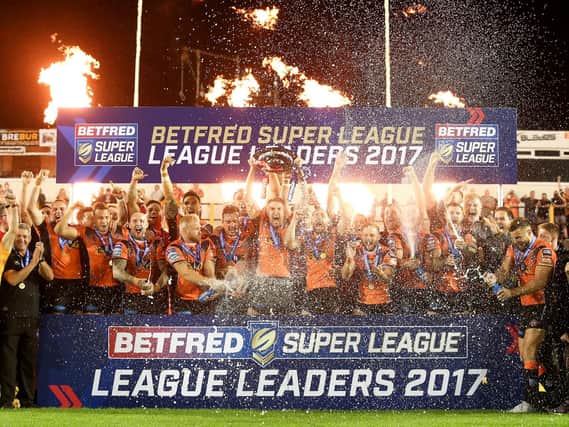 Ecstatic Castleford Tigers, above, lift the League Leaders Shield last year - in stark contrast to St Helens this time around. (Alex Whitehead/SWpix.com)