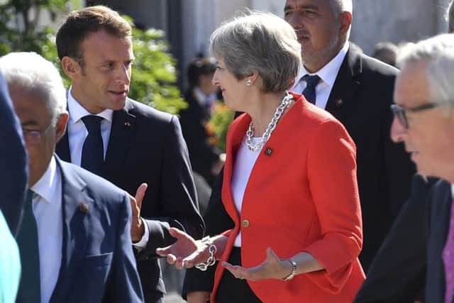 Theresa May chats to Frech president Emmanuel Macron who has dismissed Brexiteers as liars.