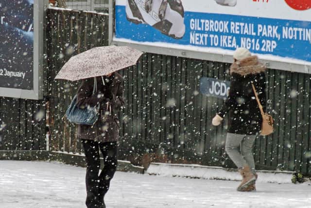 Pedestrians enjoy the snow in Leeds city centre