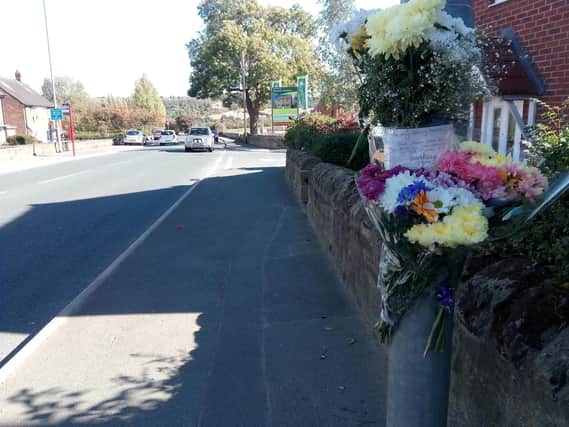 Floral tributes left at the scene of the accident, in Wide Lane, Morley