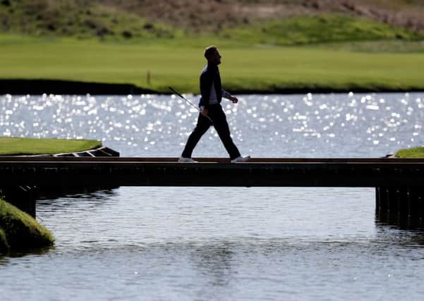 Europe's Tyrrell Hatton walks across a bridge towards the 15th green at Le Golf National, Saint-Quentin-en-Yvelines, Paris (Picture: David Davies/PA Wire).