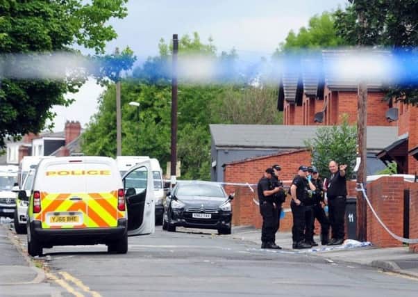 Police at the scene in Reginald Street, Chapeltown, where Christopher Lewis was fatally shot