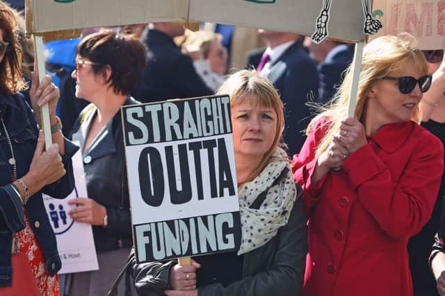 Helen Longton-Howorth (centre), headteacher of Carden Primary School in Brighton, holds a placard in Parliament Square, London, as headteachers from across England and Wales prepare to march on Downing Street to demand extra cash for schools. PRESS ASSOCIATION Photo. Picture date: Friday September 28, 2018. See PA story EDUCATION Headteachers. Photo credit should read: Kirsty O'Connor/PA Wire