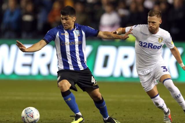 Sheffield Wednesday's Fernando Forestieri (left) and Leeds United's Barry Douglas battle for the ball at Hillsborough. Picture: Richard Sellers/PA