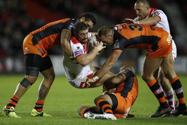 St Helens' Kyle Amor is tackled by Castleford Tigers Jesse Sene-Lefao (left), Jake Webster (centre) and Liam Watts (right). Picture: Martin Rickett/PA.
