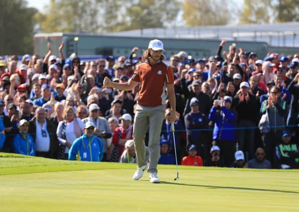 Team Europe's Tommy Fleetwood celebrates his putt on the 3rd green during the Foursomes match.