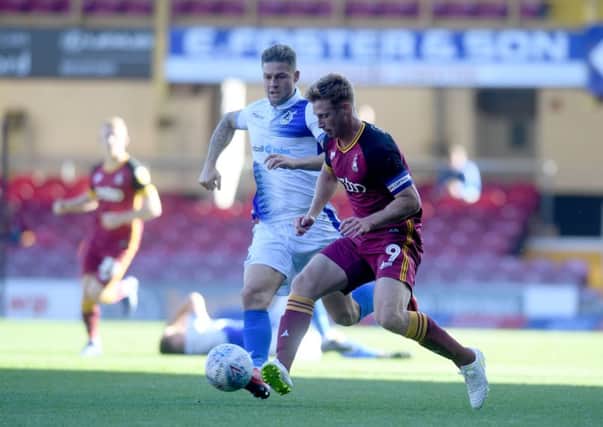 Eoin Doyle, of Bradford City, controls the ball in front of James Clarke, of Bristol Rovers.