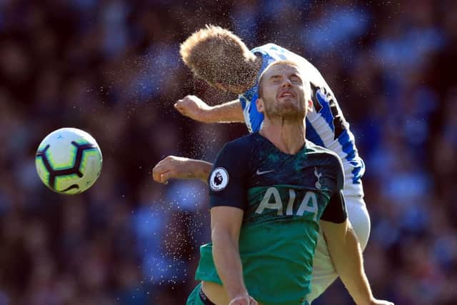 Tottenham Hotspur's Eric Dier (front) and Huddersfield Town's Laurent Depoitre battle for the ball at the John Smith's Stadium. Picture: Mike Egerton/PA