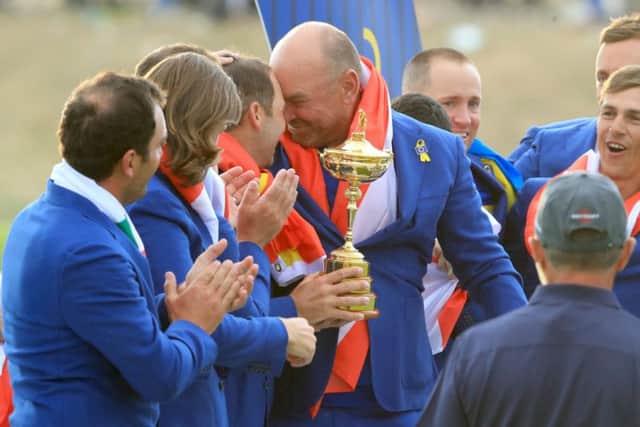 Team Europe captain Thomas Bjorn (centre) and his team celebrate with the Ryder Cup during day three of the Ryder Cup at Le Golf National. Picture: Gareth Fuller/PA