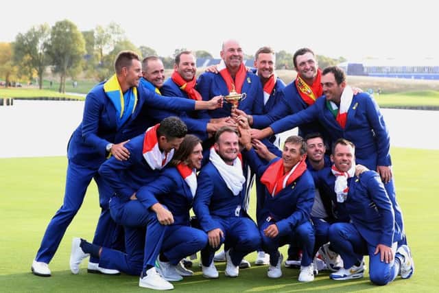 Team Europe's (top row, from the left to right) Henrik Stenson, Justin Rose, Alex Noren, Sergio Garcia, captain Thomas Bjorn, Ian Poulter, Jon Rahm, Paul Casey (bottom row, from left to right) Tommy Fleetwood, Tyrrell Hatton, Thorbjorn Olesen, Rory McIlroy and Francesco Molinari celebrate with the Ryder Cup. Picture: Adam Davy/PA