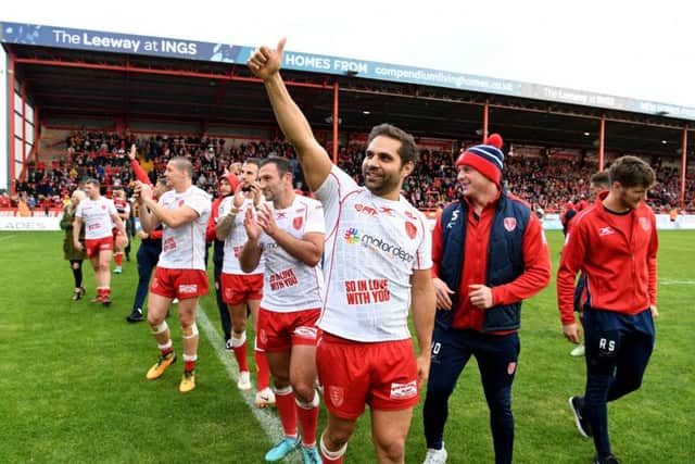 Maurice Blair, of Hull Kingston Rovers, celebrating to the fans with teammates on the field after the match.