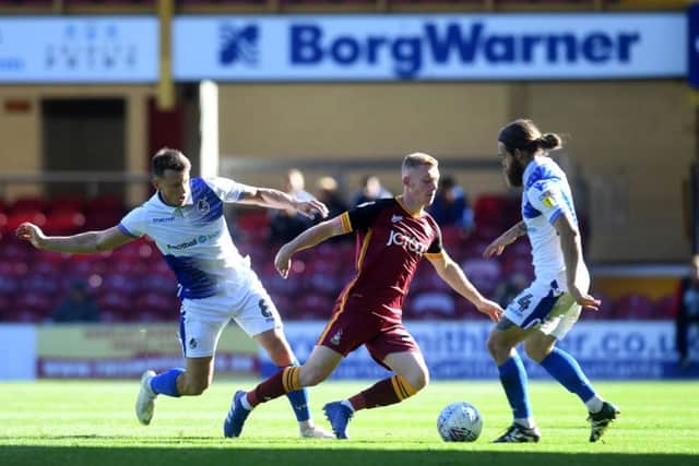 MIDFIELD BATTLE: Ollie Clarke, of Bristol Rovers, tackles Lewis O'Brien, of Bradford City. Picture: James Hardisty.