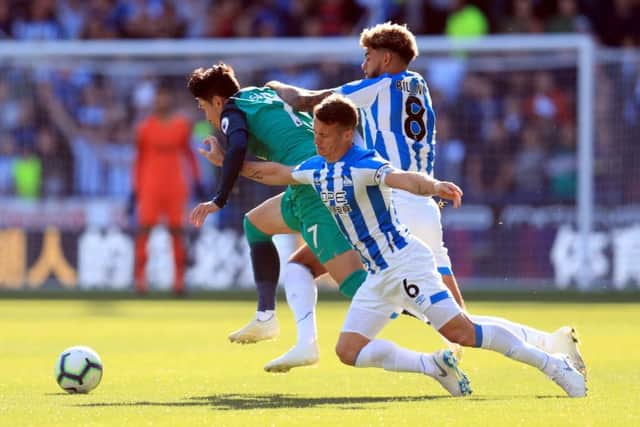 Tottenham Hotspur's Son Heung-min is challenged by Huddersfield Town's Philip Billing (right) and Jonathan Hogg at the John Smith's Stadium. Picture: Mike Egerton/PA