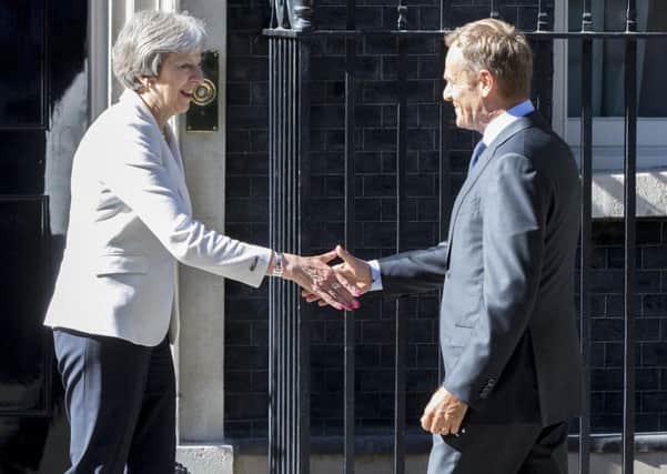 Theresa May meets Donald Tusk outside 10 Downing Street.