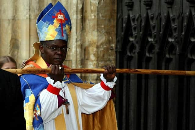 File photo dated 30/11/05 of the Archbishop of York Dr John Sentamu knocking on the door of York Minster with his crook before his enthronement service.