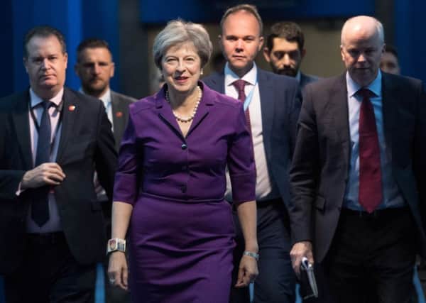 Theresa May and her aides arriving at the Tory conference in Birmingham yesterday.