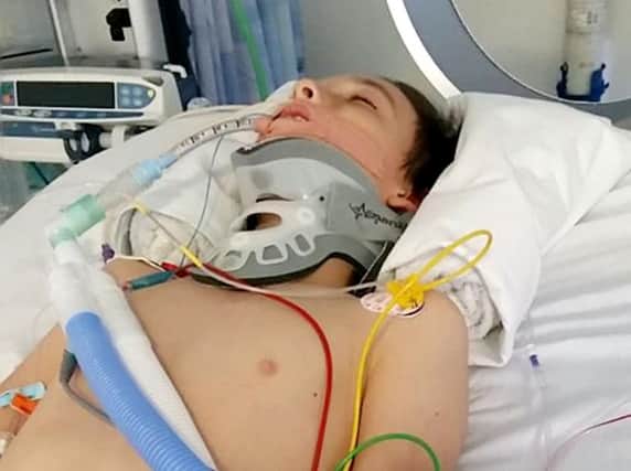 The mother of a young teenager who was knocked out at his school has told how his heart stopped twice after being floored by a single punch.