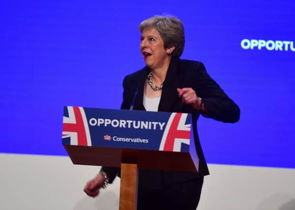 Prime Minister Theresa May dances as she arrives on stage to make her speech at the Conservative Party annual conference at the International Convention Centre, Birmingham.