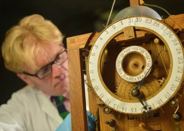 Conservator Matthew Read repairs a replica of the 18th Harrison Clock, in Leeds City Museum. PIC: SWNS