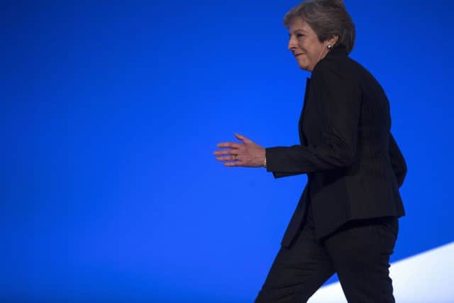 Theresa May dances onto the stage at the Tory conference.